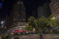 Beautiful view of night New York city landscape. Empty park square with two bystanders. New York.