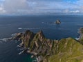 View of the northwestern coast of AndÃÂ¸ya, VesterÃÂ¥len, Norway with rugged mountains and cliffs as well as bird rock BleiksÃÂ¸ya. Royalty Free Stock Photo