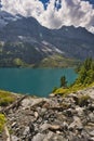 Beautiful view of Oeschinensee, Oeschinen Lake by Kandersteg, Switzerland. Turquoise lake with steep mountains and rocks in ba