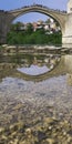 Beautiful view of the Old Bridge in Mostar, Bosnia and Herzegovina. Reflection of a bridge in river Neretva Royalty Free Stock Photo