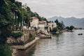 Beautiful view on old buildings and boats on lake in Stresa city, Italy. Architecture and shore on Lago Maggiore in sunny day on Royalty Free Stock Photo