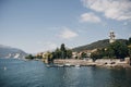 Beautiful view on old buildings and boats on lake in Stresa city, Italy. Architecture and shore on Lago Maggiore in sunny day on Royalty Free Stock Photo