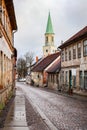 Beautiful view of old countryside brick road street with white church tower in the backgorund Royalty Free Stock Photo