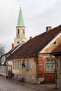 Beautiful view of old countryside brick road street with white church tower in the backgorund Royalty Free Stock Photo