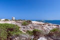 Beautiful view of the old observation tower Torre De Ses Portes and the rocky coast of the Ibiza island Royalty Free Stock Photo
