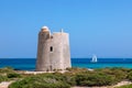 Beautiful view of the old observation tower Torre De Ses Portes and sailing yacht off the coast of Ibiza island Royalty Free Stock Photo