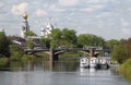 A beautiful view of the old Russian city of Vologda: a white church with golden domes on the river bank, a bridge, ships Royalty Free Stock Photo