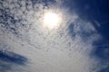 Beautiful view onto sunbeams with some lens flares and clouds on a blue sky