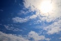 Beautiful view onto sunbeams with some lens flares and clouds on a blue sky