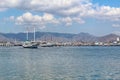 Beautiful View Over the Calm Sea Water Accompanied by Floating Boats Large Mountains with Clear Cloudy Blue Sky Background Royalty Free Stock Photo