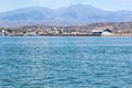 Beautiful View Over the Calm Sea Water Accompanied by Floating Boats Large Mountains with Clear Cloudy Blue Sky Background Royalty Free Stock Photo