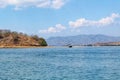 Beautiful View Over the Calm Sea Water Accompanied by Floating Boats Large Mountains with Clear Cloudy Blue Sky Background Royalty Free Stock Photo