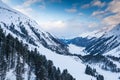 Beautiful view over frozen mountain lake in the Alps in winter time