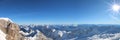 A beautiful view over the german and austrian alps from the mountain `zugspitze` in a winter wonderland with blue sky