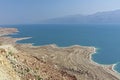 Beautiful view of the whimsically shaped sandy and salty coastline of the blue dead sea in Israel.