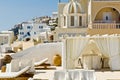 Santorini, patio on steep hill with view over terraced buildings on Caldera at Aegean Sea. Santorini, beautiful island in Greece Royalty Free Stock Photo