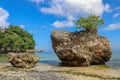 A beautiful view of Padang Padang beach in Bali, Indonesia. Giant boulders and rock formations jutting out over the Indian Ocean