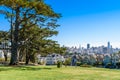 Beautiful view of Painted Ladies, colorful Victorian houses located near scenic Alamo Square in a row, on a summer day with blue