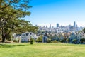 Beautiful view of Painted Ladies, colorful Victorian houses located near scenic Alamo Square in a row, on a summer day with blue