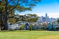 Beautiful view of Painted Ladies, colorful Victorian houses located near scenic Alamo Square in a row, on a summer day with blue