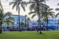 Beautiful view of palm tree park in front of hotels along Ocean Drive in Miami Beach with presence of vibrant restaurants