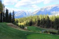 A beautiful view of a par 3 golf hole on a course with mountains in the background Royalty Free Stock Photo