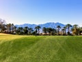 A beautiful view of a par 4 surrounded by mountains and palm trees in the background on the desert oasis of Palm Spri Royalty Free Stock Photo