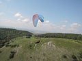 Beautiful view of paragliding over mountain with blue sky during sunrise Royalty Free Stock Photo