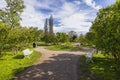 Beautiful view of park with flower beds, forest trees, walking paths and benches for relaxing on sunny summer day. Royalty Free Stock Photo