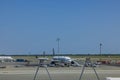 Beautiful view of parked planes of different airlines at JF Kennedy airport in New York on blue sky background. Royalty Free Stock Photo