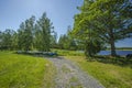 Beautiful view of parking place for small boats in the forest near lake coast line. Inverted boats under tall green trees on blue Royalty Free Stock Photo