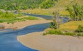 A beautiful view of a peaceful river running through a valley in the Rocky Mountains of Colorado