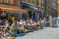 Beautiful view of people in outdoor cafÃ© decorated with Swedish flags. Stockholm. Royalty Free Stock Photo