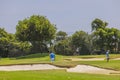 Beautiful view of people playing golf on golf course in hotel.