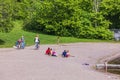 Beautiful view of people on sandy beach of lake in summer day.