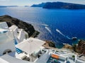 Beautiful view of picturesque village of Oia with traditional white architecture and windmills in Santorini island. Greece. Vacati Royalty Free Stock Photo