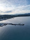 Beautiful view of a pier on the sea with boats under the blue cloudy sky during sunrise Royalty Free Stock Photo