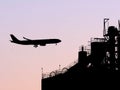 Beautiful view of a plane getting ready to land in the shade during sunset