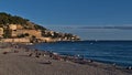 Beautiful view of popular beach Plage des Ponchettes in city Nice at the French Riviera with tourists. Royalty Free Stock Photo