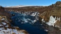 Beautiful view of popular Hraunfossar cascades near HÃÂºsafell in western Iceland on sunny winter day with wild river. Royalty Free Stock Photo