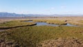 Beautiful view of Prairie fields with blue lake under blue sky with clouds on the horizon Royalty Free Stock Photo