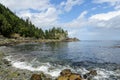 A beautiful view of a pretty beach surrounded by forest and clean ocean water, in Gwaii Haanas National Park Reserve, Haida Gwaii,