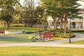 Beautiful view of public park in countryside show freshness landscape with trees, bicycle, wooden bench and green grass.