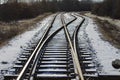 Beautiful view of railways in a snowy field with trees during sunrise