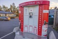 Beautiful view of red white gas automat on car parking.