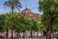 Beautiful view of a religious building next to the trees in the streets of Cordoba, Spain. Royalty Free Stock Photo