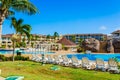 Beautiful view of resort grounds, swimming pools with people relaxing and enjoying their vacation time in background on sunny day Royalty Free Stock Photo