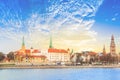 View of the Riga Castle, St. Peter`s Church and the tower of the Dome Cathedral on the banks of the Daugava River in Riga Royalty Free Stock Photo