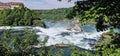 Beautiful view of the river of Rhine Falls framed with greenery in Switzerland Royalty Free Stock Photo