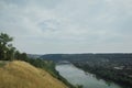 Beautiful view on the river and village in summer. Amazing natural landscape with dry yellow grass and green trees Royalty Free Stock Photo